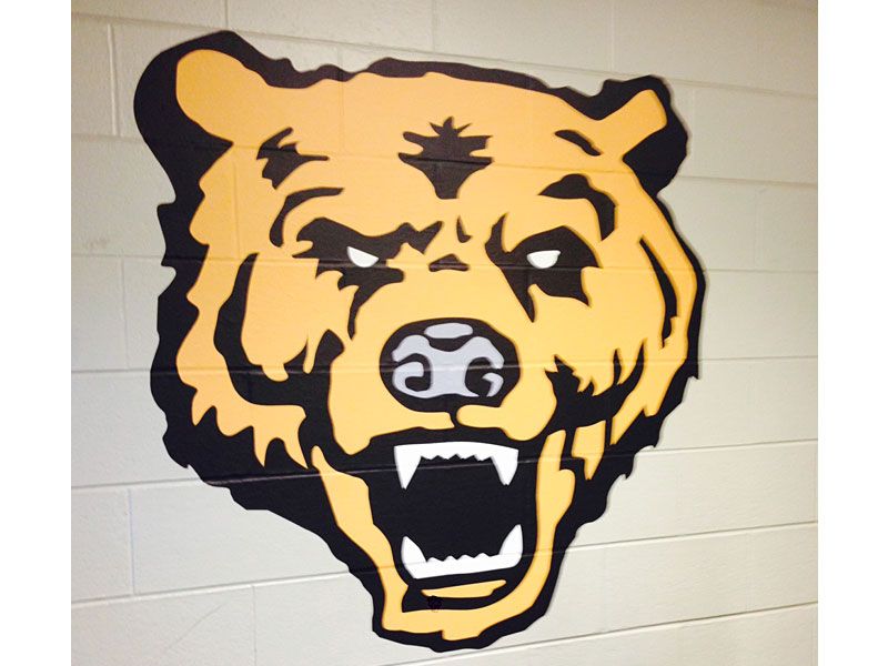 power grip mascot on block wall