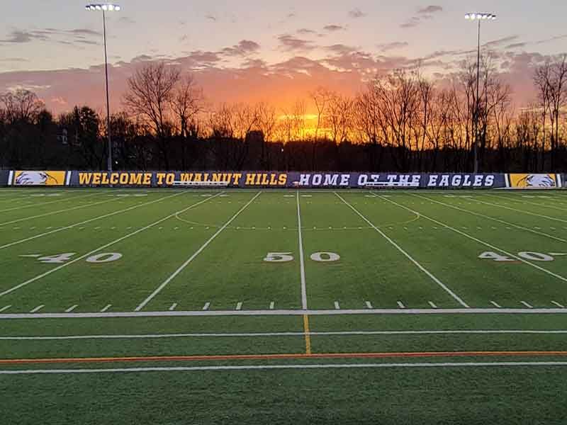walnut hills high school mesh fence banner at sunset